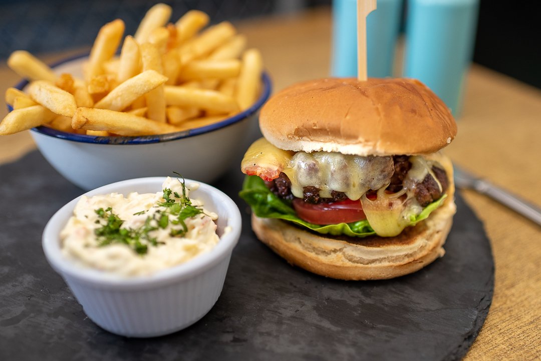 Steak burger with onion rings at Seventh Wave